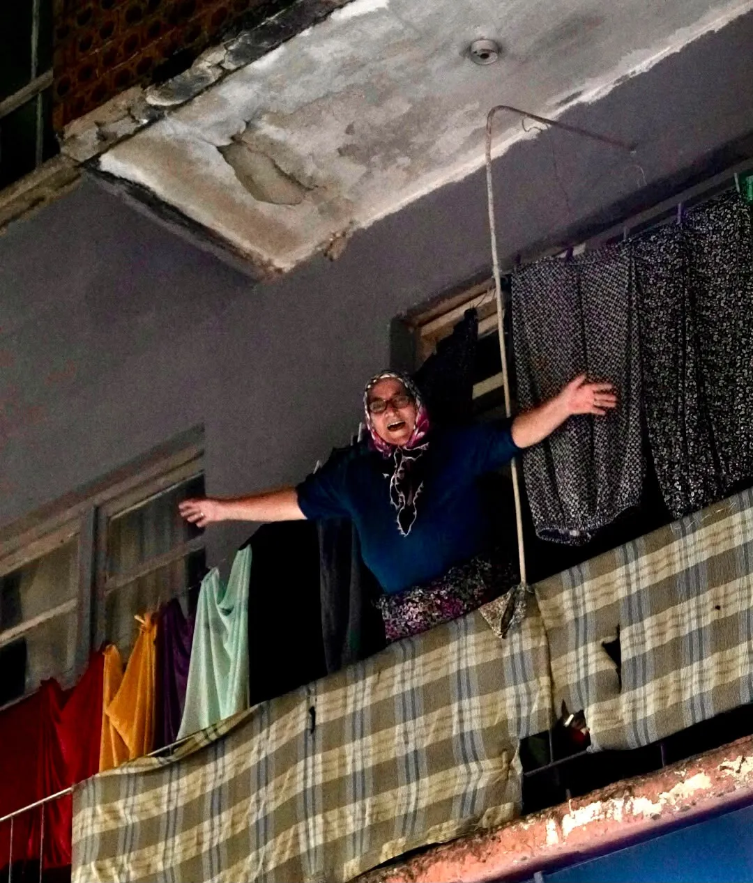 Serik'te 29 Ekim yürüyüşünü balkondan selamlayan bir kadın